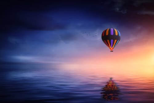 hot air balloon over the ocean...