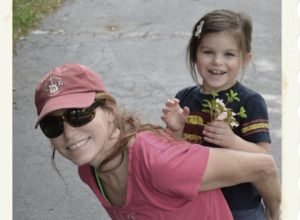 a mom with her daughter holding flowers...